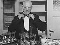 A wine waiter fixes his bow tie.
undated