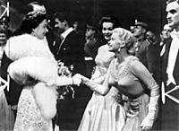 Jayne Mansfield curtseys to Queen Elizabeth II.
1