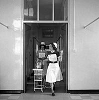 A nurse and a ward sister taking medical equipment