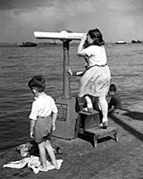 A girl looks through an automatic telescope at the