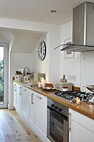 Long wooden kitchen worksurface with extractor hoo