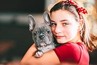 Girl hugging pet dog