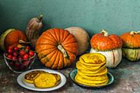 Autumn still life with pumpkins and pumpkin pancak
